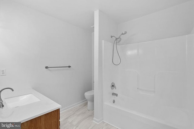 full bathroom featuring toilet, baseboards, vanity, and shower / bathtub combination