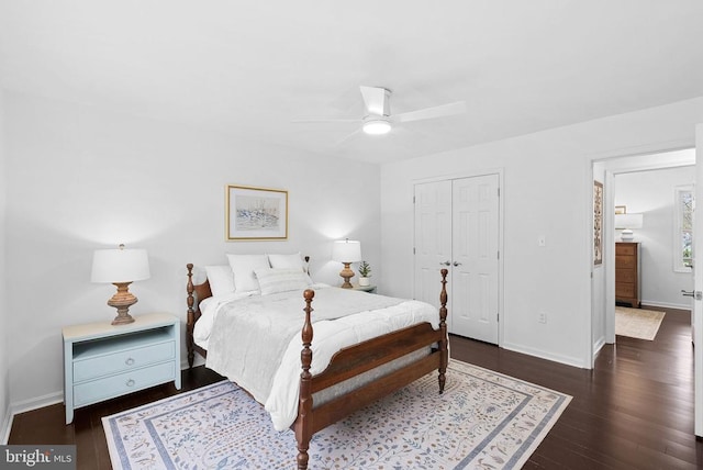 bedroom with hardwood / wood-style floors, a closet, and baseboards