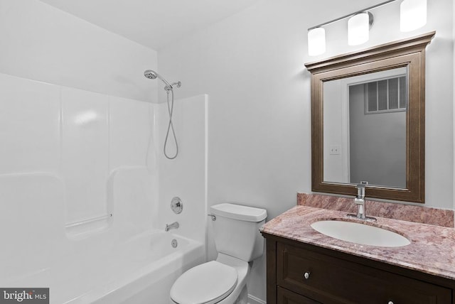 bathroom featuring toilet, vanity, and washtub / shower combination