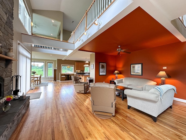 603 Dabneys Rd, Raphine, VA 24472 - living area with ceiling fan, light wood-type flooring, baseboards, and a stone fireplace