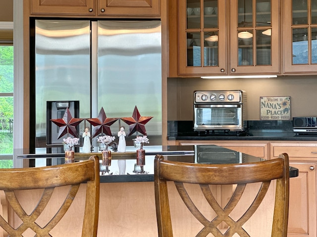 603 Dabneys Rd, Raphine, VA 24472 - kitchen featuring a healthy amount of sunlight, dark countertops, stainless steel refrigerator with ice dispenser, and glass insert cabinets