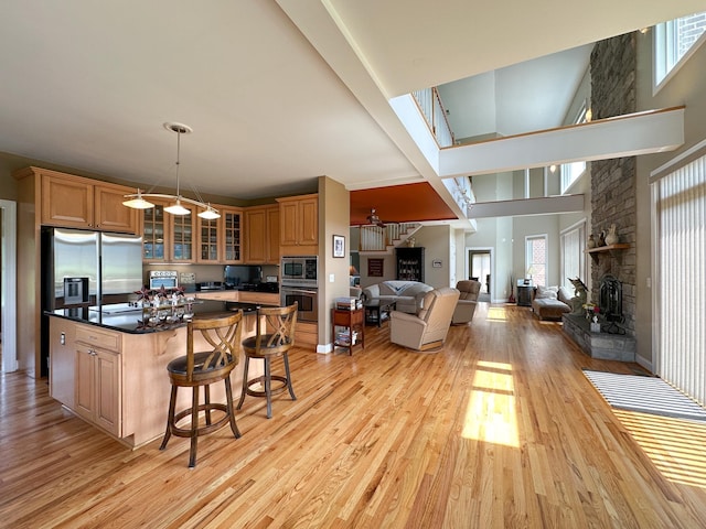 603 Dabneys Rd, Raphine, VA 24472 - kitchen featuring stainless steel appliances, a high ceiling, a kitchen island, and light wood-type flooring