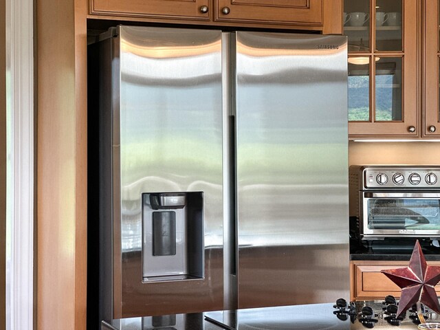 603 Dabneys Rd, Raphine, VA 24472 - kitchen featuring dark countertops, a toaster, stainless steel refrigerator with ice dispenser, and glass insert cabinets