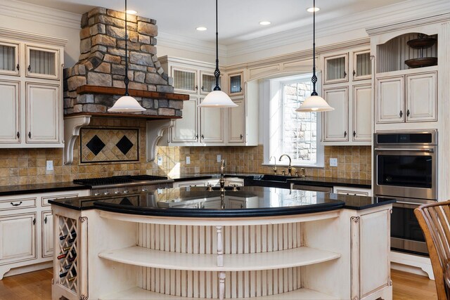 1767 Goose Creek Rd, Waynesboro, VA 22980 - kitchen with open shelves, appliances with stainless steel finishes, a kitchen island with sink, a sink, and crown molding