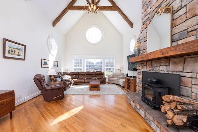 1767 Goose Creek Rd, Waynesboro, VA 22980 - living room with high vaulted ceiling, a wood stove, wood finished floors, beam ceiling, and healthy amount of natural light