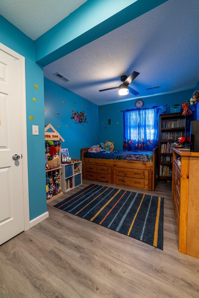 2786 Fleeburg Rd, Shenandoah, VA 22849 - bedroom with a textured ceiling, a ceiling fan, visible vents, and wood finished floors