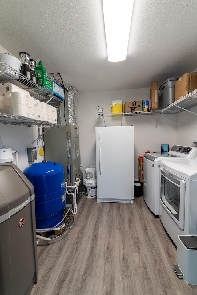 2786 Fleeburg Rd, Shenandoah, VA 22849 - clothes washing area with washer and clothes dryer, laundry area, and light wood-type flooring