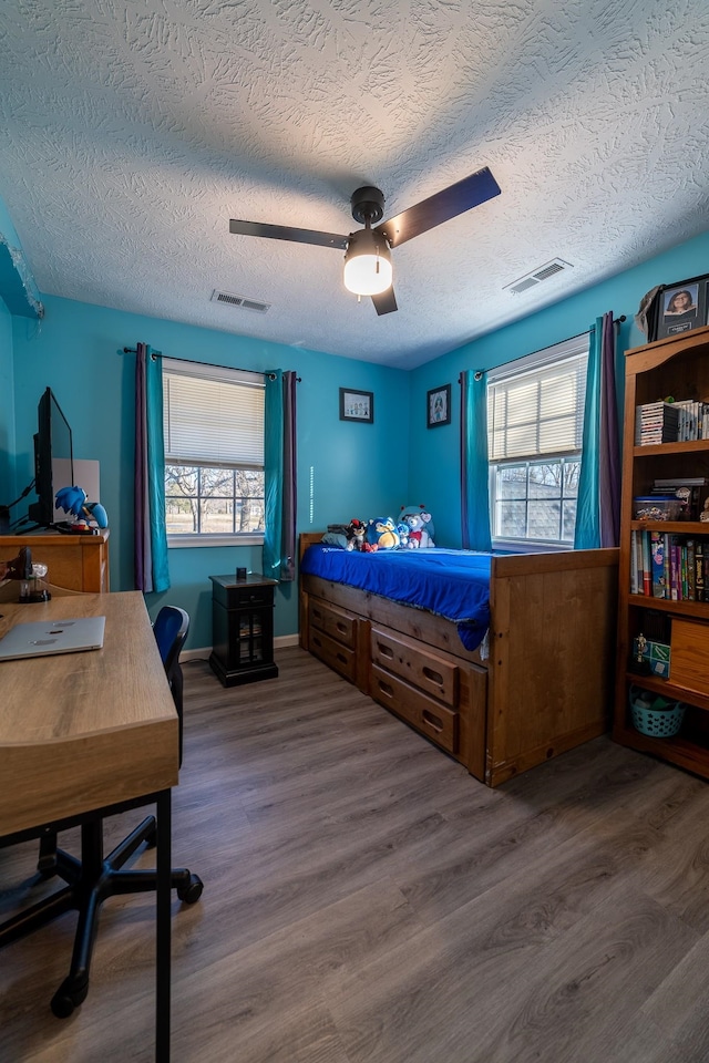 2786 Fleeburg Rd, Shenandoah, VA 22849 - bedroom with a textured ceiling, a ceiling fan, visible vents, and wood finished floors