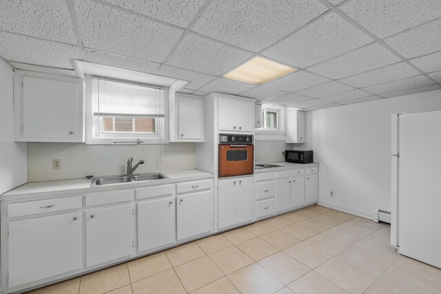 633 Wayne Ave S, Waynesboro, VA 22980 - kitchen with a baseboard heating unit, white appliances, light countertops, and a sink
