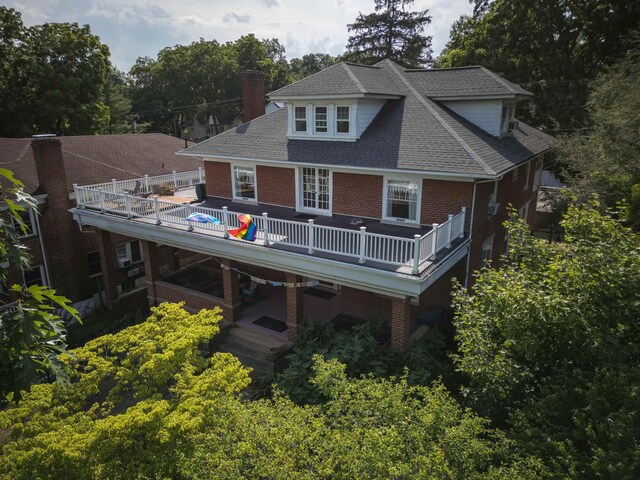 633 Wayne Ave S, Waynesboro, VA 22980 - back of house with brick siding, a wooden deck, a chimney, roof with shingles, and view of wooded area