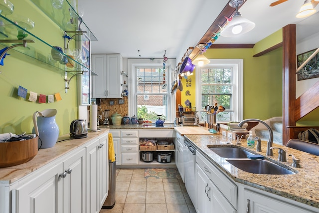 633 Wayne Ave S, Waynesboro, VA 22980 - kitchen featuring a sink, dishwasher, white cabinets, light tile patterned floors, and light stone countertops