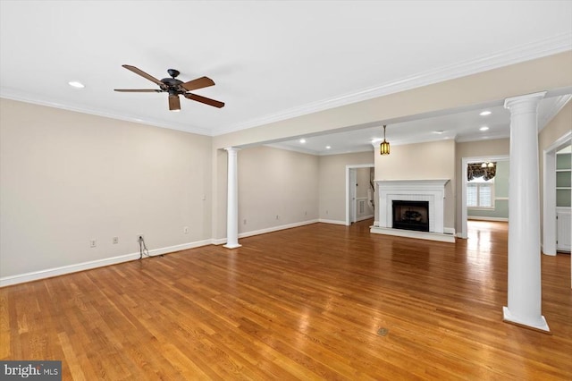 3905 Corbin Hall Ln, Fredericksburg, VA 22408 - unfurnished living room featuring decorative columns, light wood-style floors, a ceiling fan, recessed lighting, and a fireplace with raised hearth