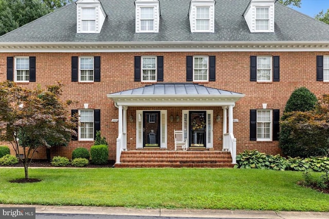 3905 Corbin Hall Ln, Fredericksburg, VA 22408 - colonial-style house featuring brick siding, a front yard, a porch, and a shingled roof
