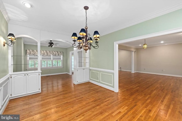 3905 Corbin Hall Ln, Fredericksburg, VA 22408 - empty room featuring a chandelier, light wood-style floors, ornamental molding, a ceiling fan, and a wainscoted wall