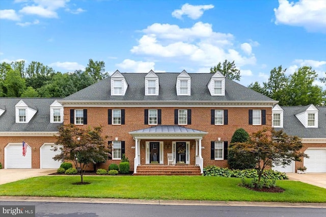 3905 Corbin Hall Ln, Fredericksburg, VA 22408 - georgian-style home with brick siding, a front yard, concrete driveway, and a garage