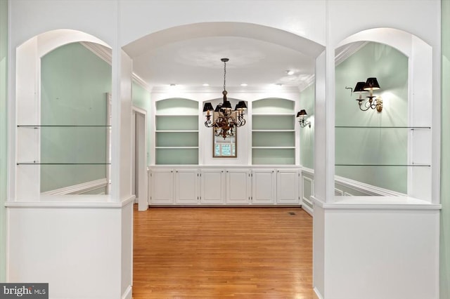 3905 Corbin Hall Ln, Fredericksburg, VA 22408 - hallway with light wood finished floors, ornamental molding, a chandelier, and built in features
