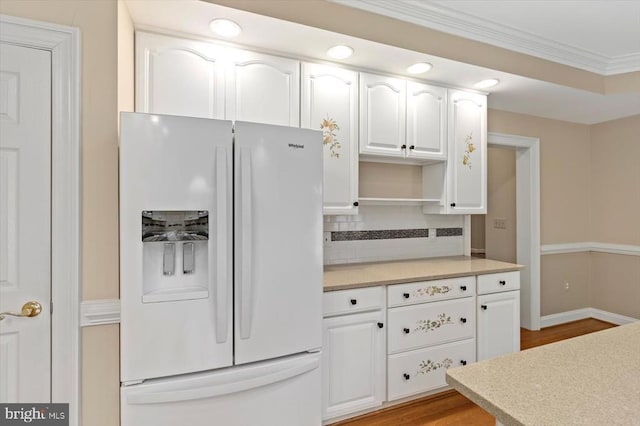 3905 Corbin Hall Ln, Fredericksburg, VA 22408 - kitchen featuring white fridge with ice dispenser, white cabinetry, light countertops, crown molding, and decorative backsplash