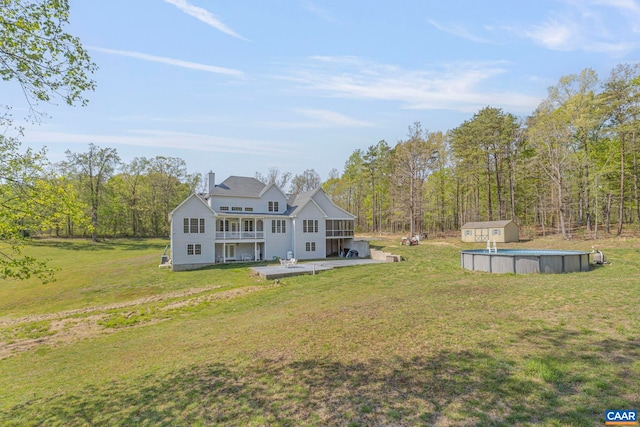 1130 Race Ground Rd, Rochelle, VA 22738 - rear view of property featuring an outbuilding, a lawn, an outdoor pool, and a shed