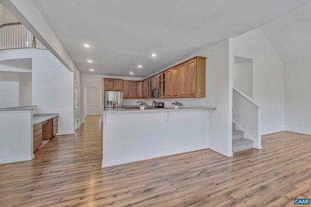 1130 Race Ground Rd, Rochelle, VA 22738 - kitchen with recessed lighting, brown cabinetry, a peninsula, light wood-style floors, and stainless steel appliances