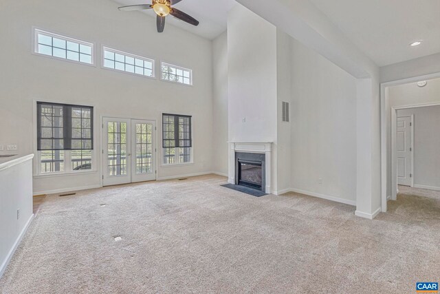 1130 Race Ground Rd, Rochelle, VA 22738 - unfurnished living room with visible vents, carpet flooring, a ceiling fan, a high ceiling, and a fireplace with flush hearth