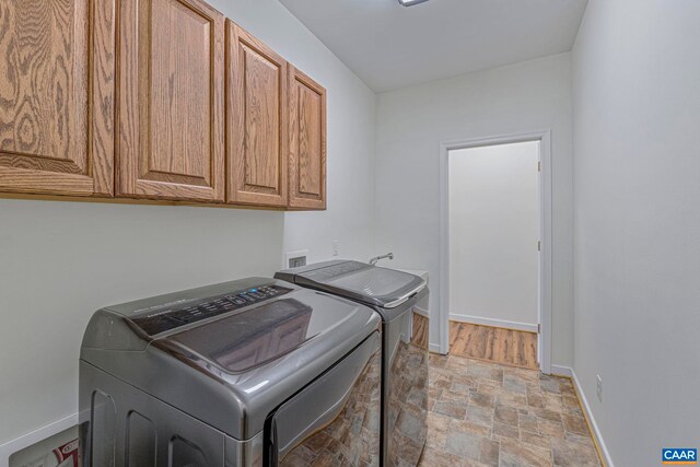 1130 Race Ground Rd, Rochelle, VA 22738 - washroom with washer and dryer, cabinet space, baseboards, and stone finish floor