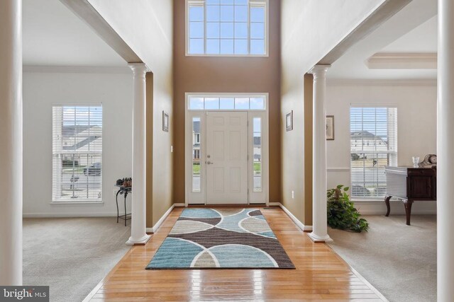 5831 Deep Creek Dr, Fredericksburg, VA 22407 - foyer with ornate columns, crown molding, carpet floors, wood finished floors, and a towering ceiling
