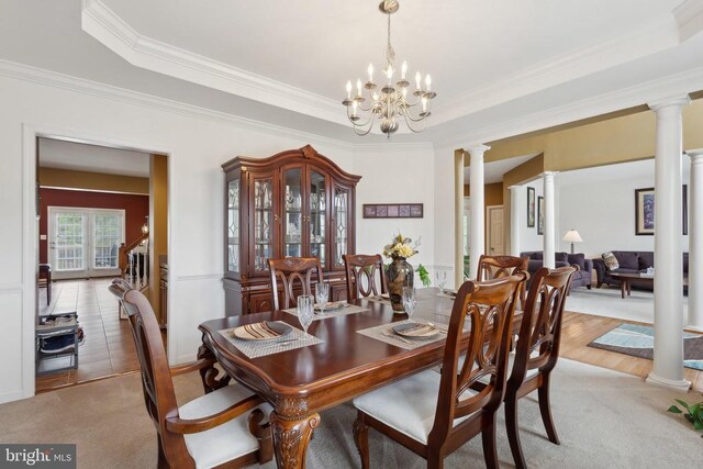 5831 Deep Creek Dr, Fredericksburg, VA 22407 - dining space with ornate columns, a tray ceiling, ornamental molding, a chandelier, and light carpet
