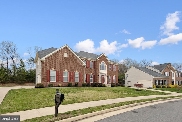 5831 Deep Creek Dr, Fredericksburg, VA 22407 - georgian-style home with brick siding, a front lawn, driveway, and an attached garage