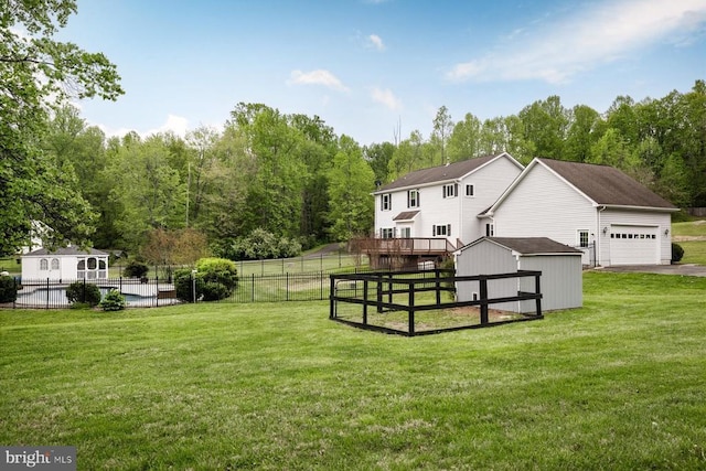 view of yard with an outdoor structure, a storage shed, and fence