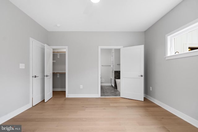 10643 Settle School Rd, Rixeyville, VA 22737 - unfurnished bedroom featuring a spacious closet, baseboards, and light wood-type flooring