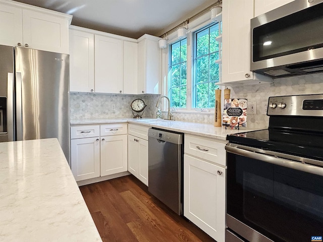 1203 Afton Mountain Rd, Afton, VA 22920 - kitchen featuring appliances with stainless steel finishes, decorative backsplash, dark wood-style floors, and white cabinetry