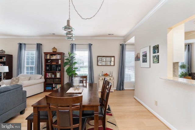 11200 Scottwood Ln N, Fredericksburg, VA 22407 - dining area with healthy amount of natural light, light wood-style floors, and ornamental molding
