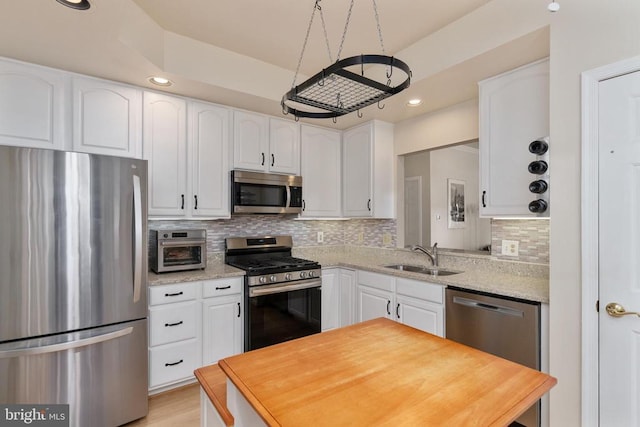 11200 Scottwood Ln N, Fredericksburg, VA 22407 - kitchen with stainless steel appliances, white cabinetry, recessed lighting, tasteful backsplash, and light stone countertops
