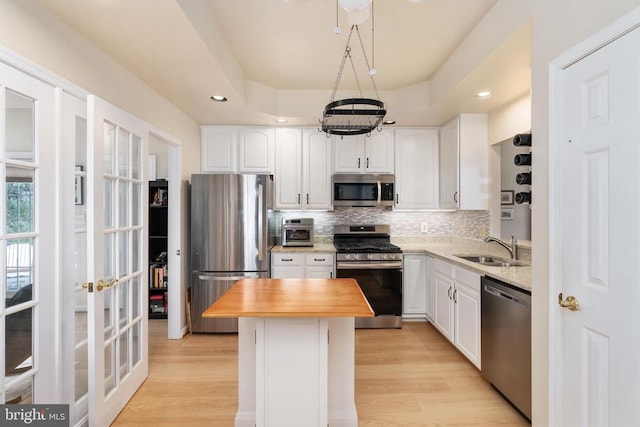 11200 Scottwood Ln N, Fredericksburg, VA 22407 - kitchen featuring appliances with stainless steel finishes, wooden counters, tasteful backsplash, white cabinetry, and light wood-type flooring