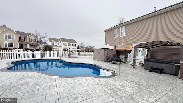 view of pool with a pergola, a patio area, a hot tub, and a gazebo