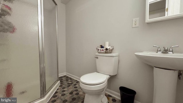 bathroom featuring toilet, sink, and walk in shower