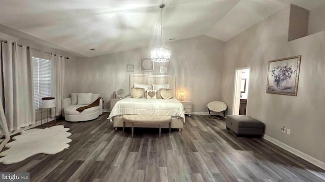 bedroom with vaulted ceiling, a chandelier, and dark hardwood / wood-style flooring