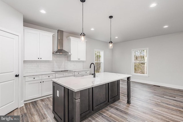26437 Pennfields Dr, Orange, VA 22960 - kitchen featuring wall chimney range hood, light wood-type flooring, healthy amount of natural light, tasteful backsplash, and recessed lighting