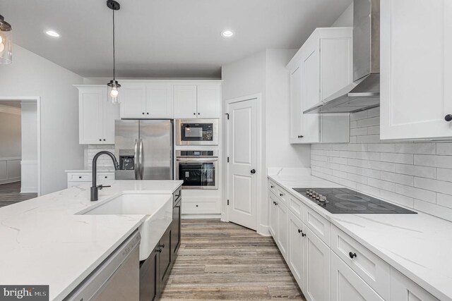 26437 Pennfields Dr, Orange, VA 22960 - kitchen featuring black appliances, wall chimney exhaust hood, a sink, white cabinetry, and recessed lighting