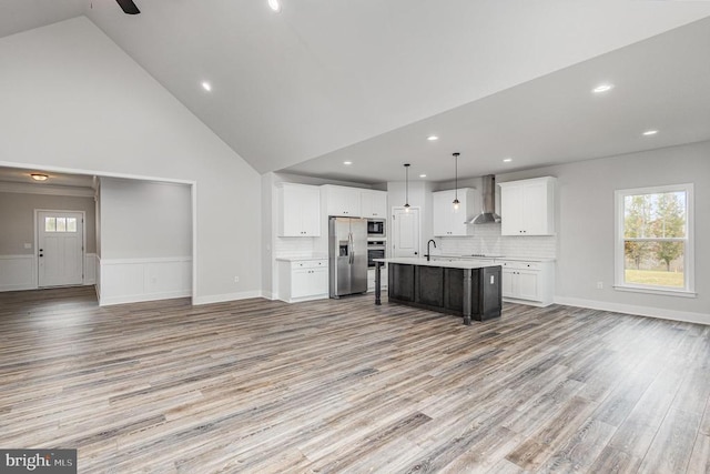 26437 Pennfields Dr, Orange, VA 22960 - kitchen with appliances with stainless steel finishes, open floor plan, wall chimney range hood, light countertops, and wainscoting