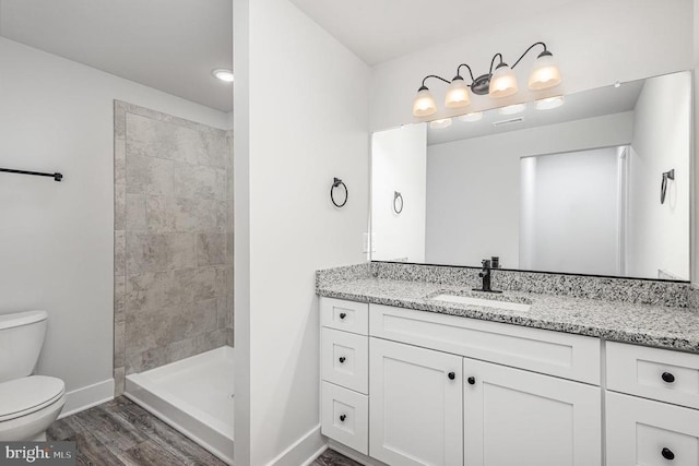 26437 Pennfields Dr, Orange, VA 22960 - full bath with toilet, baseboards, vanity, a tile shower, and wood finished floors
