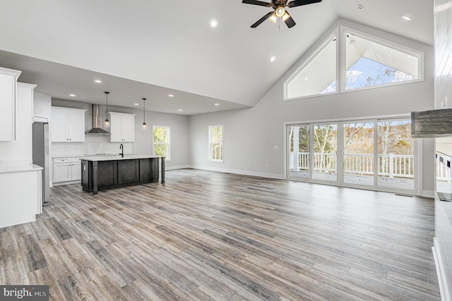 26437 Pennfields Dr, Orange, VA 22960 - unfurnished living room with high vaulted ceiling, a ceiling fan, light wood-style floors, baseboards, and recessed lighting