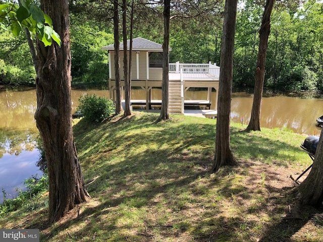 26437 Pennfields Dr, Orange, VA 22960 - view of green lawn featuring a deck with water view and a view of trees