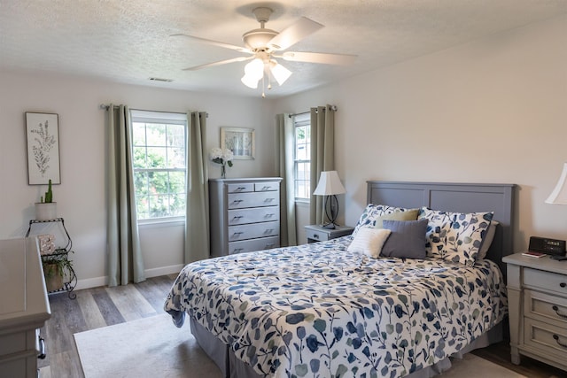 1014 22nd St E, Buena Vista, VA 24416 - bedroom with light wood finished floors, ceiling fan, and a textured ceiling