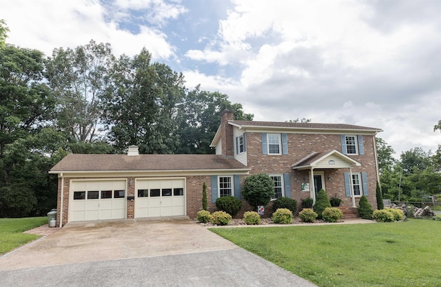 1014 22nd St E, Buena Vista, VA 24416 - colonial house featuring a garage, brick siding, a chimney, and driveway