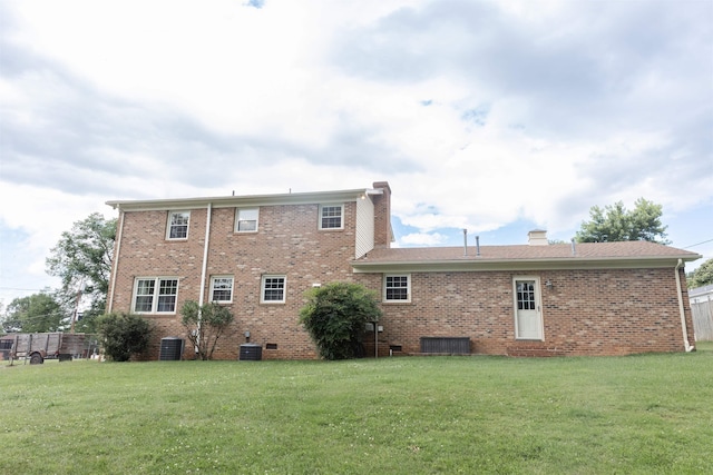 1014 22nd St E, Buena Vista, VA 24416 - back of house with a yard, a chimney, and brick siding