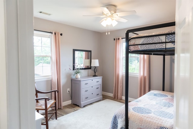 1014 22nd St E, Buena Vista, VA 24416 - bedroom with multiple windows, light wood-style flooring, and a ceiling fan
