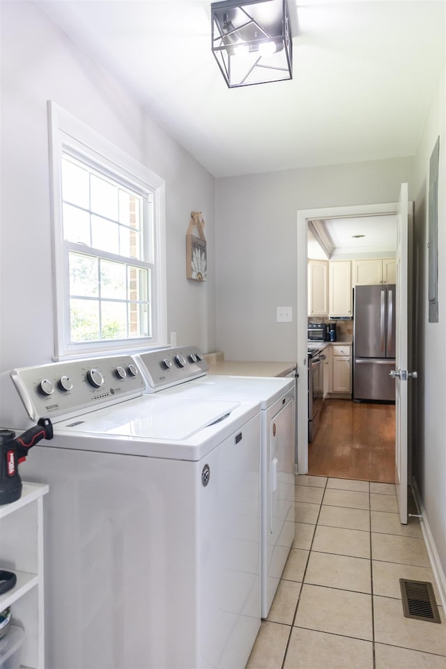 1014 22nd St E, Buena Vista, VA 24416 - laundry area with separate washer and dryer and light tile patterned floors