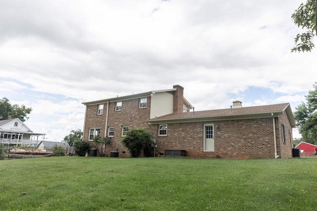 1014 22nd St E, Buena Vista, VA 24416 - back of property featuring a lawn, brick siding, and a chimney
