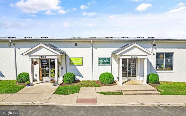  - view of front facade featuring concrete block siding
